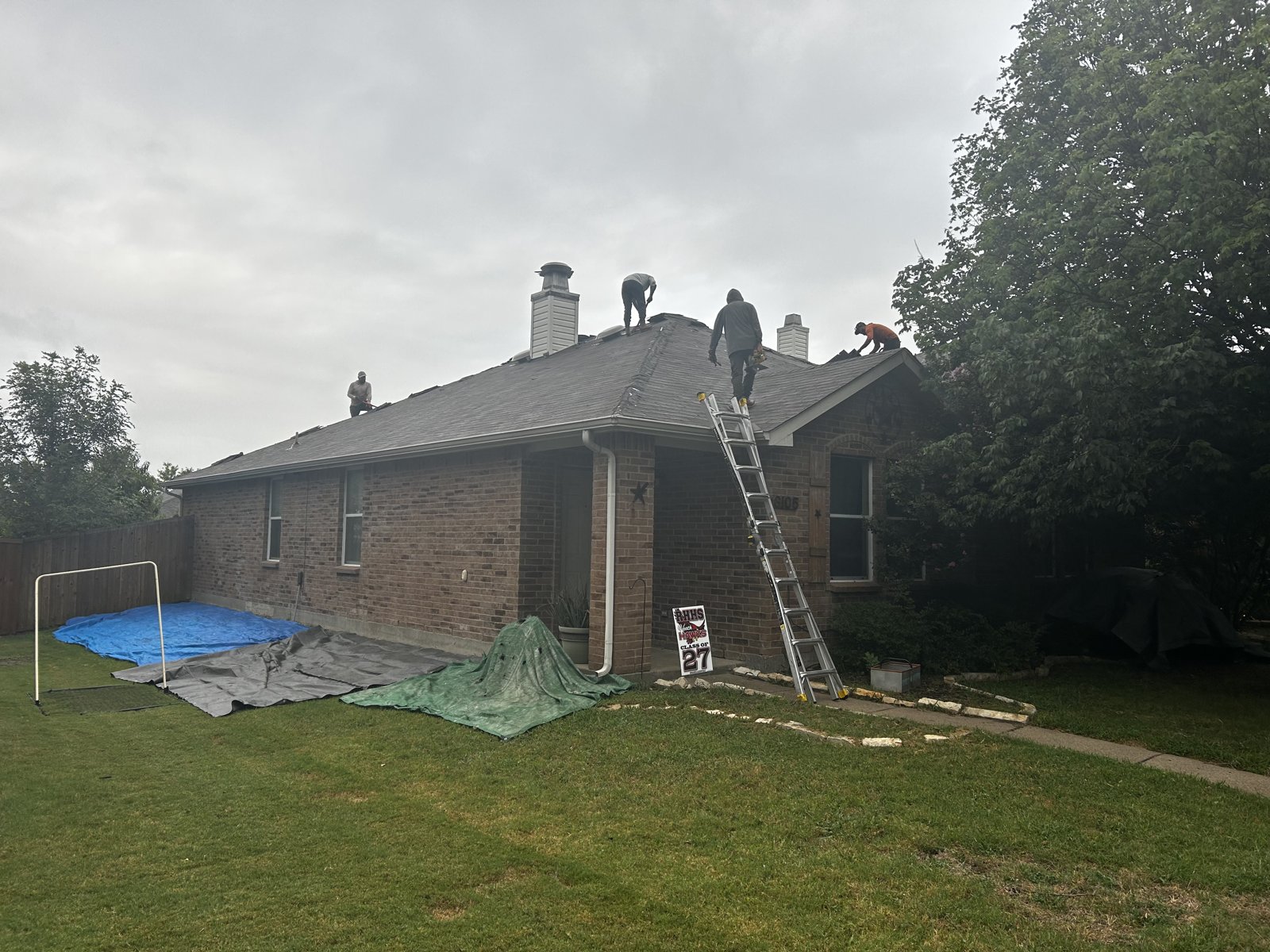 Old roof being torn off a Rockwall, TX home